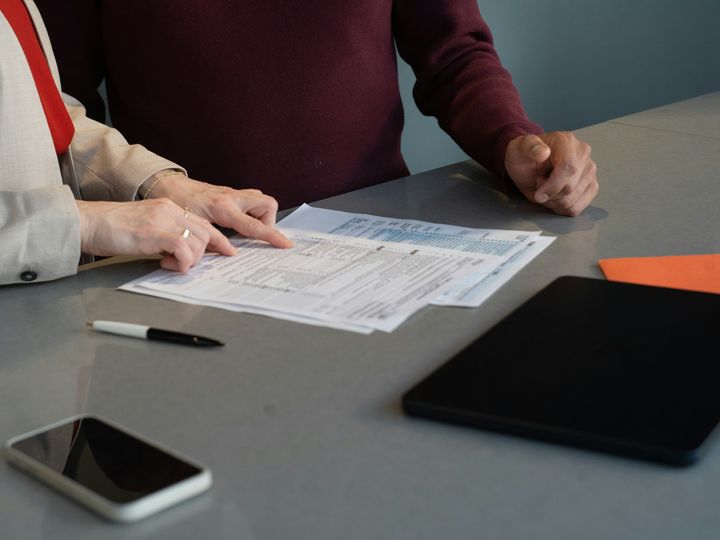 Two people reviewing research documents together