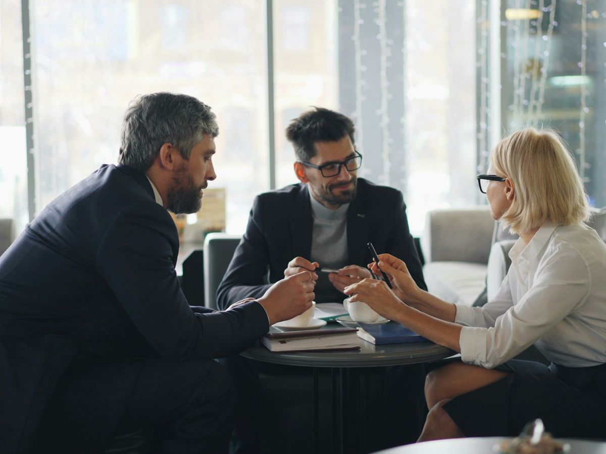 Senior colleagues in discussion around a meeting table