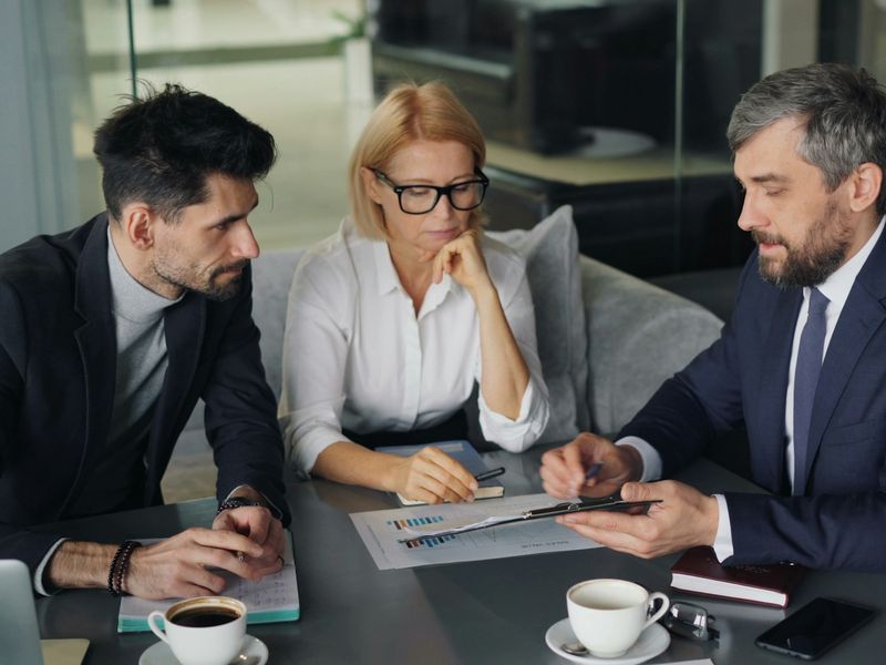 Colleagues reviewing a report together at a meeting table