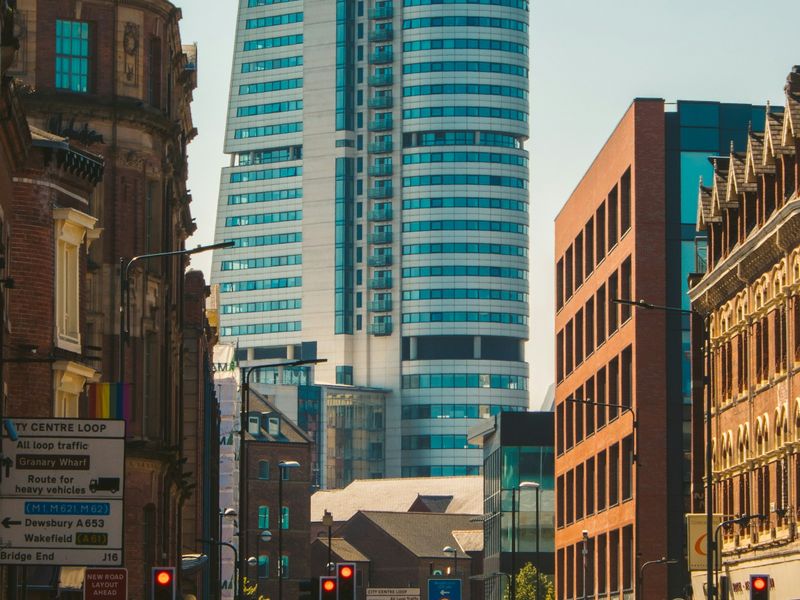 Red-brick buildings and a glass tower in Leeds